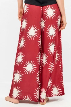 Calça comprida perna larga com estampado de sóis