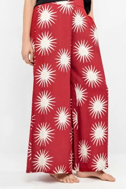 Calça comprida perna larga com estampado de sóis